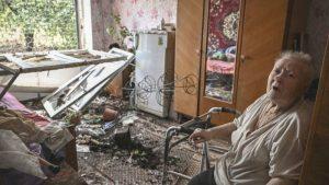 A woman sits in her destroyed flat in Soledar, not far from Severodonetsk, following a missile strike.