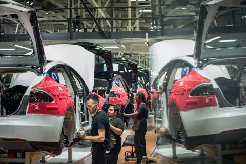 Workers assemble cars on the line at Tesla’s factory in Fremont.