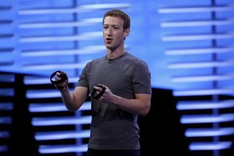 Mark Zuckerberg holds a pair of the touch controllers for the Oculus Rift virtual reality headsets on stage during the Facebook F8 conference in San Francisco, California in 2016.