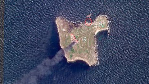 A satellite image shows thick black smoke rising from the island after a Ukrainian drone strike in May