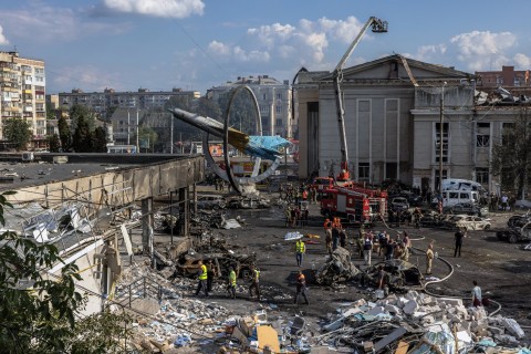 Firefighters together with rescuers, military and the police work at the site of the Russian missile strike in downtown Vinnytsia, west-central Ukraine 