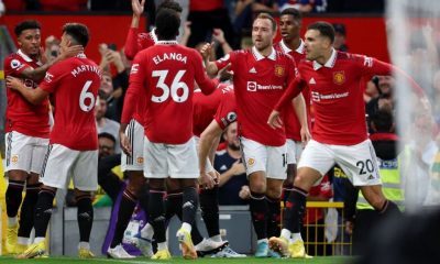 Manchester United players celebrate after scoring a goal against Liverpool in the Premier League