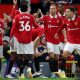 Manchester United players celebrate after scoring a goal against Liverpool in the Premier League