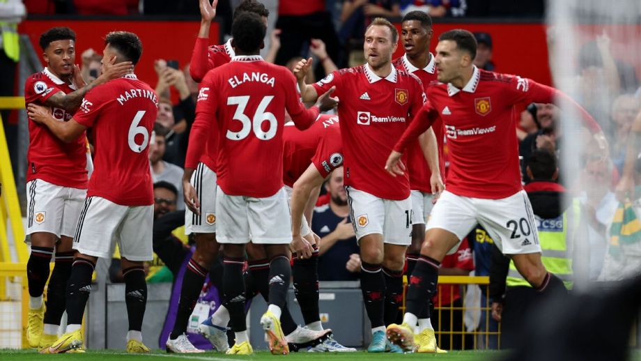 Manchester United players celebrate after scoring a goal against Liverpool in the Premier League