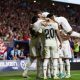 Real Madrid players celebrate after scoring a goal against Atletico in LaLiga.