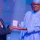 Twitter reacts to video of Teni receiving 'MON award' from President Buhari