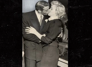 Marylin Monroe in her wedding suit, with her husband Joe DiMaggio 