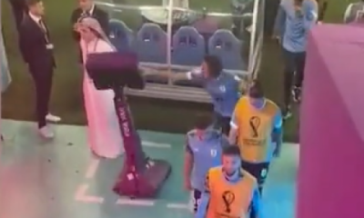Edinson Cavani pushes over the VAR screen after berating the referee as Uruguay knocked out of World Cup